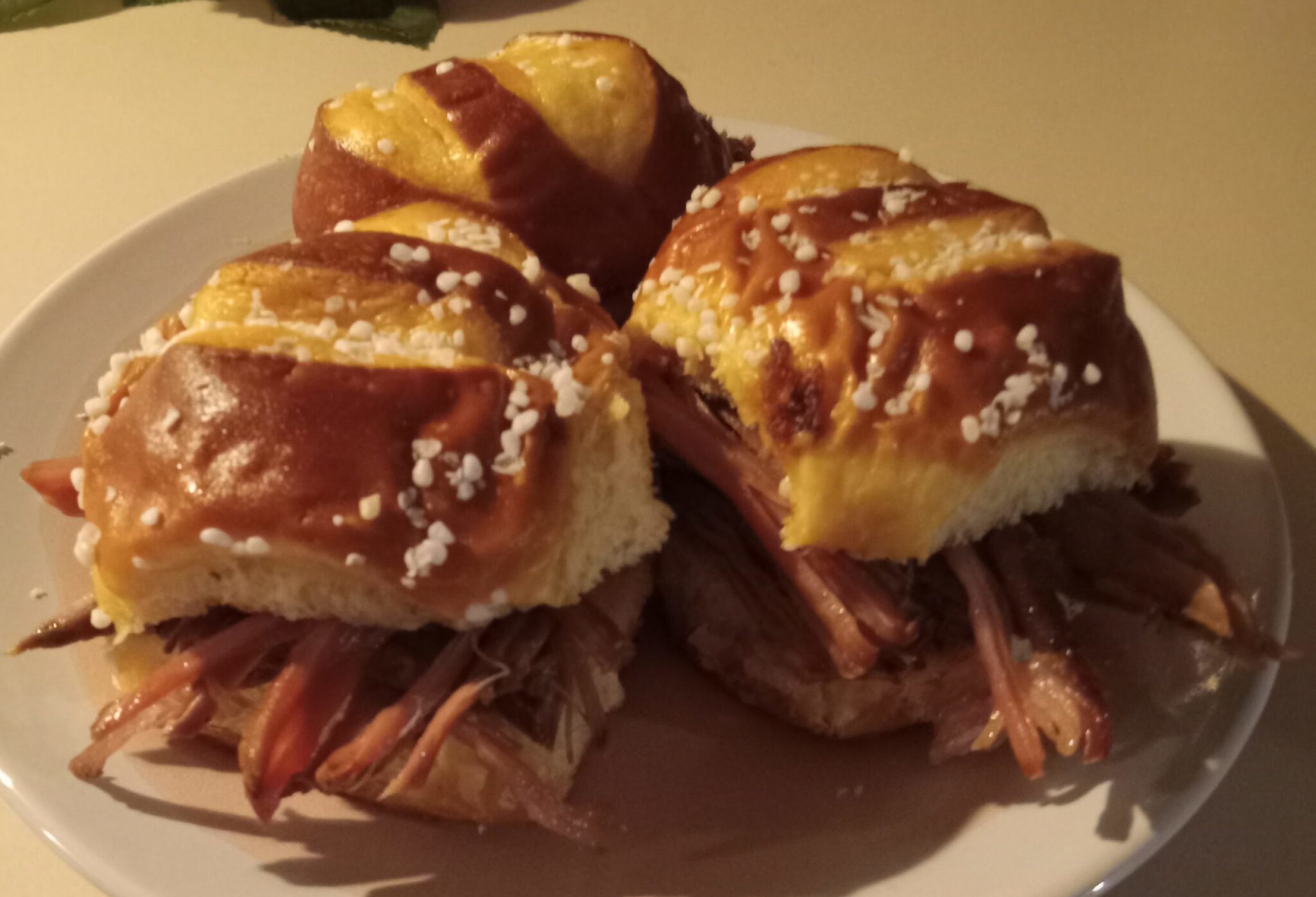 Pretzel brisket sliders, brisket sliders, leftover brisket recipes, spicy mayo sliders, pretzel buns, brisket sandwich, pickles, quick slider recipe, homemade sliders, easy brisket meal