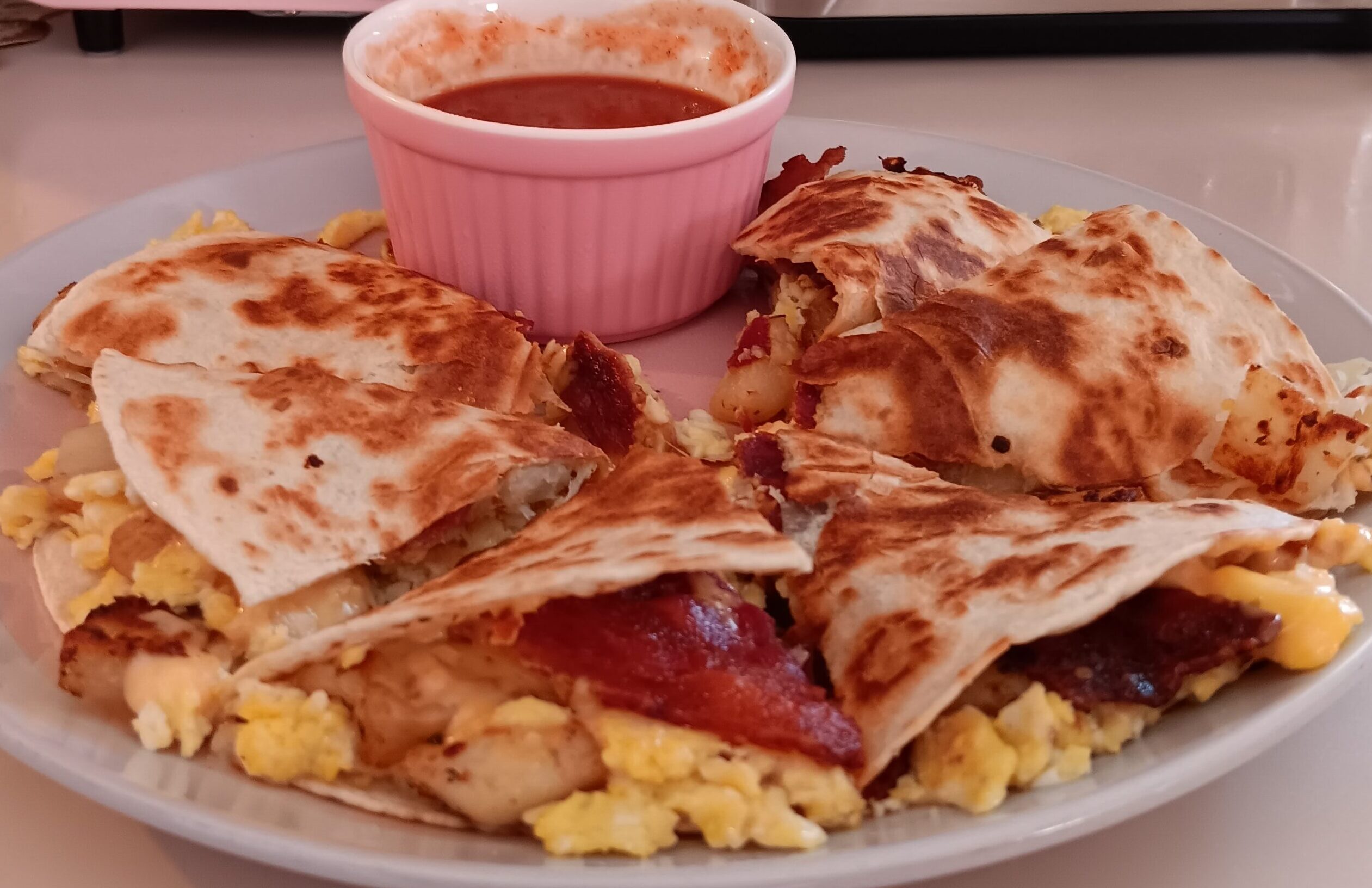 Bacon Egg Potato Cheese Quesadilla Tex Mex breakfast recipe Southern breakfast ideas Easy quesadilla recipe Breakfast quesadillas Cheesy bacon quesadilla Comfort food recipes Breakfast ideas with bacon Fluffy scrambled eggs recipe Fried potato recipes