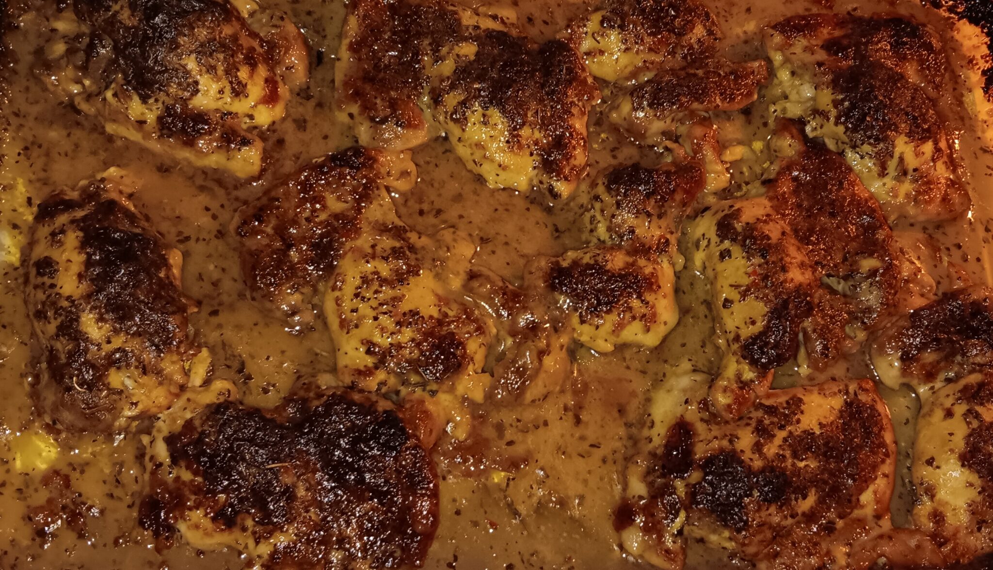 Tuscan Herb Creamed Chicken Thighs baked in a creamy Italian dressing sauce with aromatic herbs