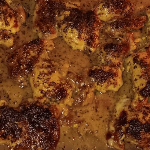 Tuscan Herb Creamed Chicken Thighs baked in a creamy Italian dressing sauce with aromatic herbs