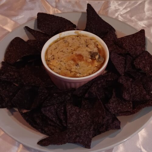 Smoky Mushroom and Tuna Dip served in a baking dish with melted cheese on top a creamy appetizer recipe perfect for parties